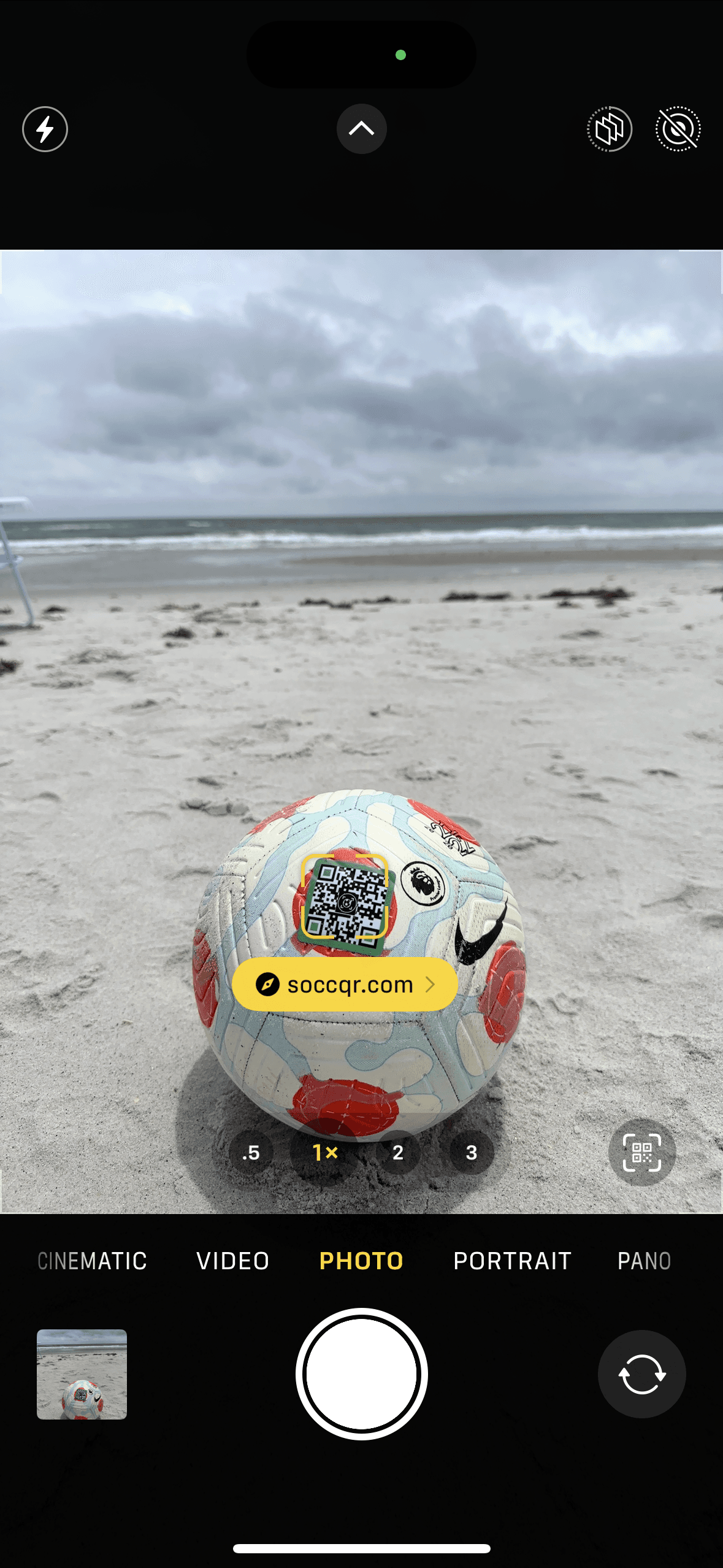 Soccer ball with SoccQR tag on the field